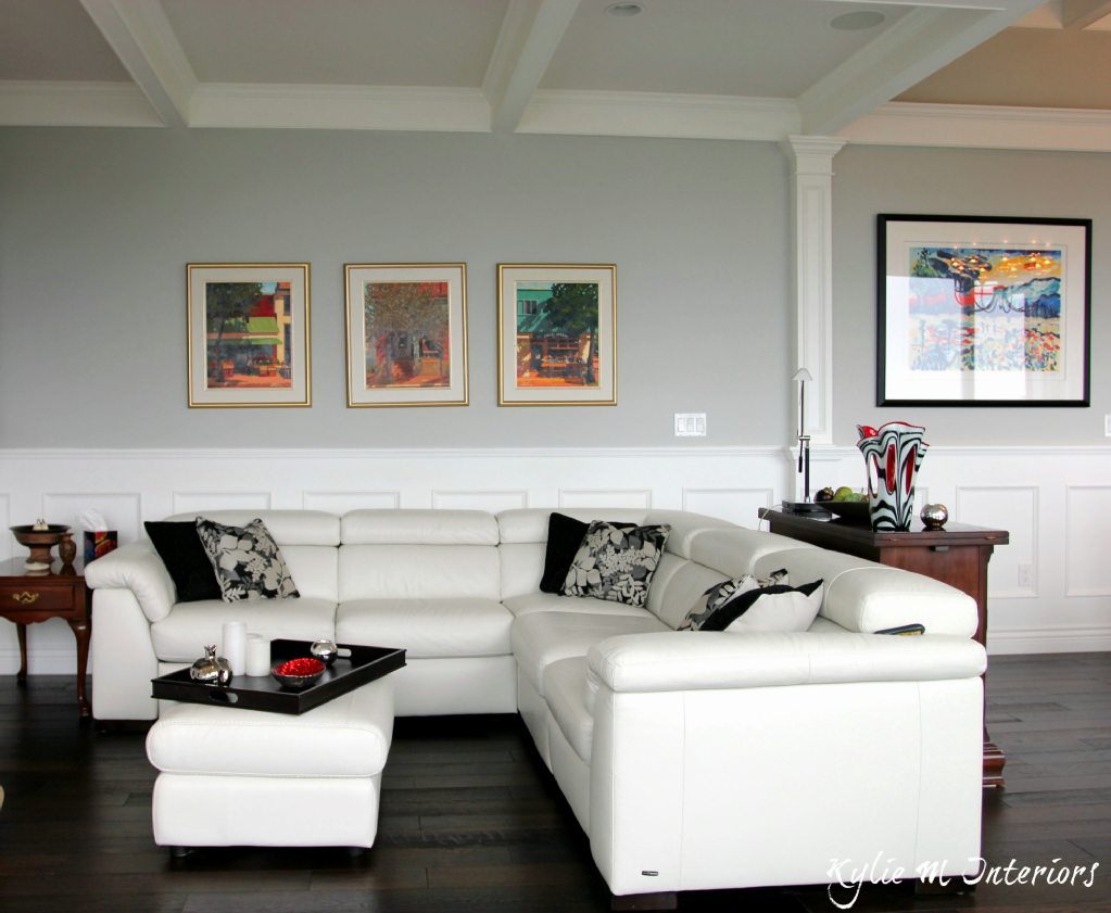leather sectional in living room showing the homeowners' artwork above