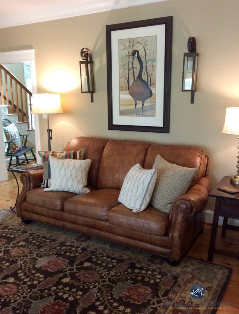 Lenox Tan Benjamin Moore in farmhouse warm living room with brown leather couch and area rug. Kylie M Interiors E-design and Colour Consulting