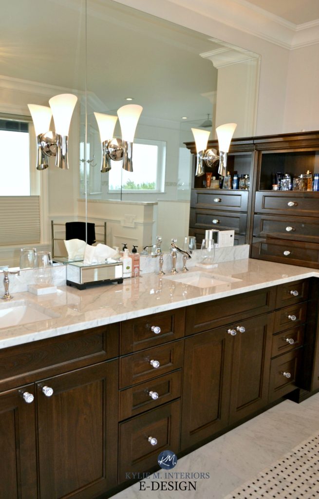 Marble countertop topped dark wood espresso vanity. Marble basketweave tile floor. Mirror and sconces. Kylie M E-design