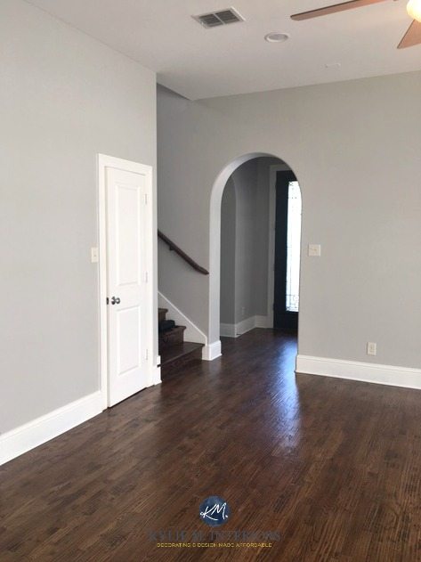 Sherwin Williams Repose Gray, a warm gray paint colour with laminate wood flooring in entryway, stairwell and great room. Kylie M Interiors E-design and Online Colour Consulting services