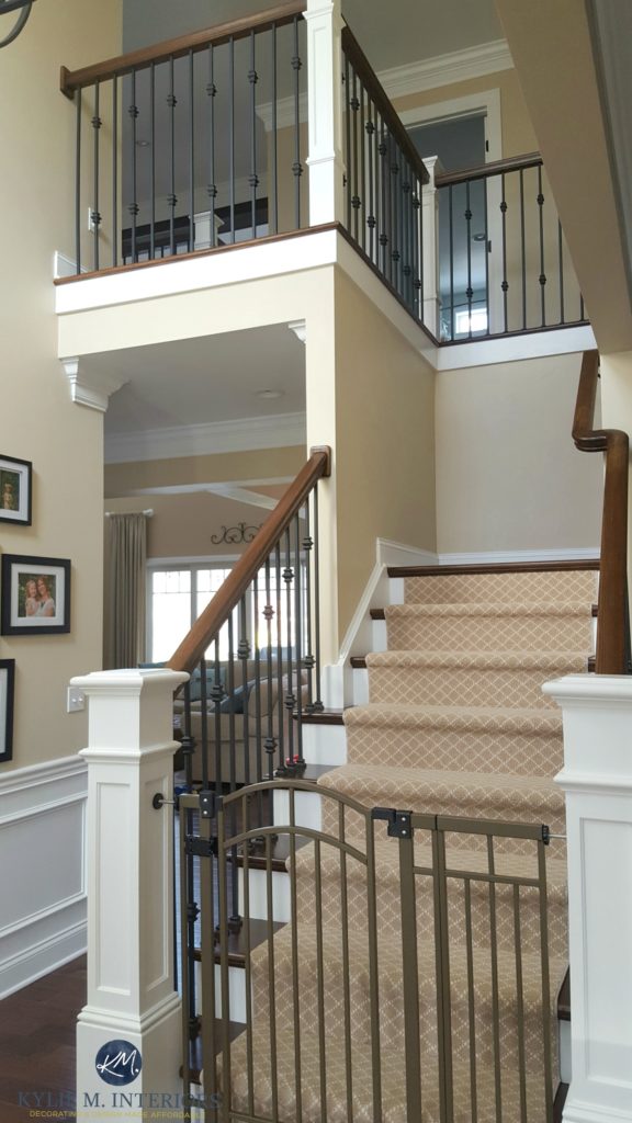 Sherwin Williams Kilim Beige in stairwell and hallway with metal, wood railing and carpet runner. Kylie M Interiors E-design