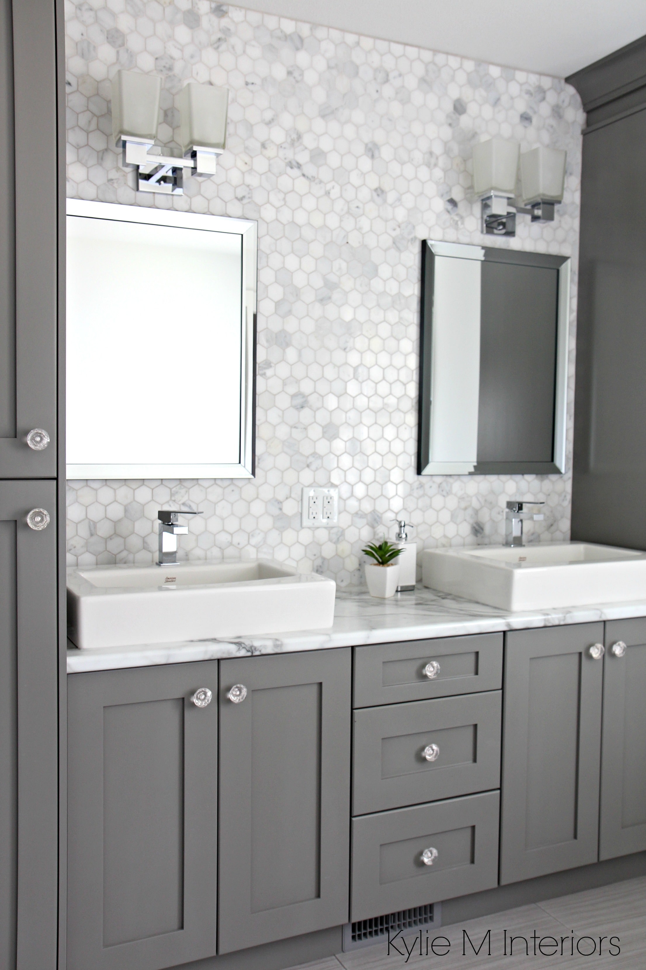 Marble backsplash in hexagon shape with vanity cabinets painted Chelsea Gray, double sinks and chrome accents by Kylie M Interiors