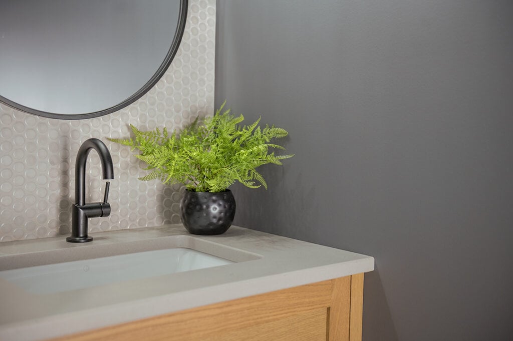 Benjamin Moore Storm Sky best dark gray paint colour. Concrete look countertop, oak wood vanity, penny tile, black fixtures. Kylie M Edesign