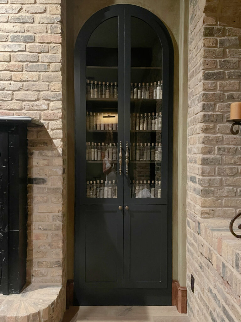 Farrow and Ball Blue Black paint color, brick fireplace, built ins with arched top. Tuscan style home modern and updated. Kylie M ONline paint color consulting