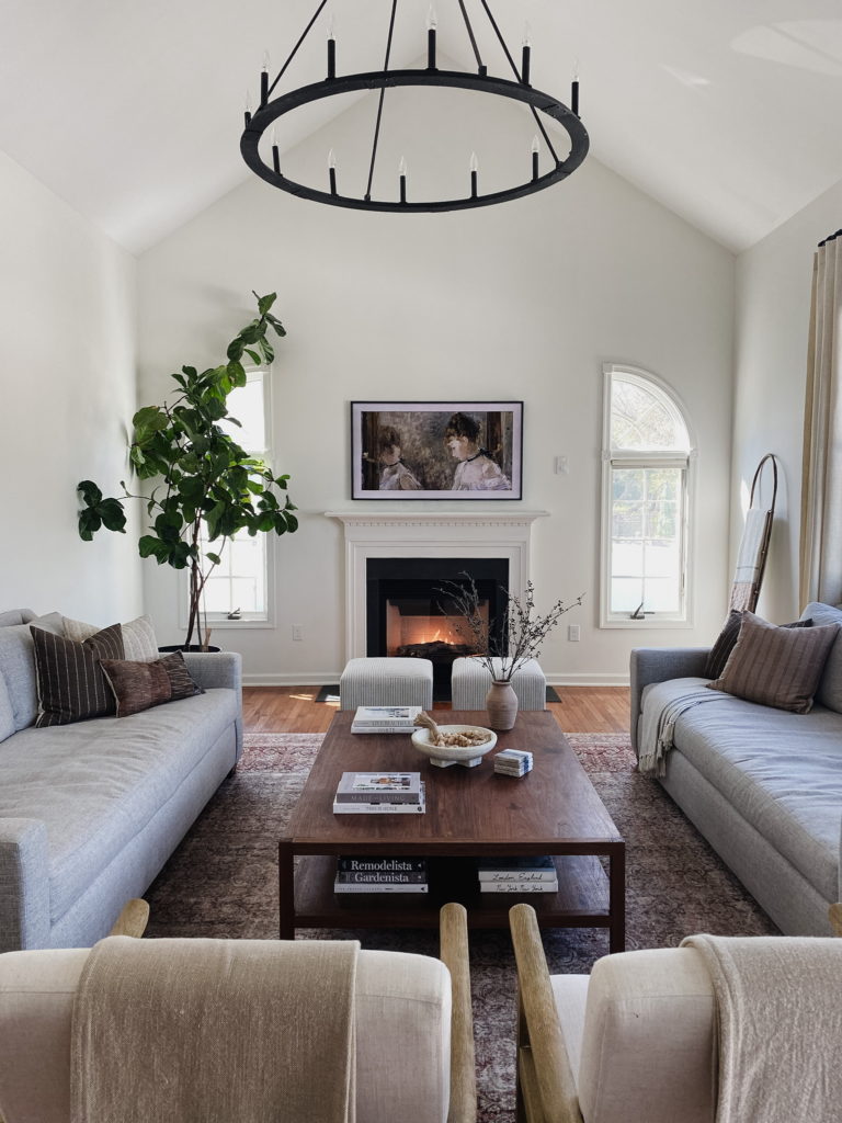 Fireplace with tv, round black chandelier, wall paint Sherwin Williams Alabaster, neutral home decor. Kylie M Interiors Edesign, Jenna Christian home
