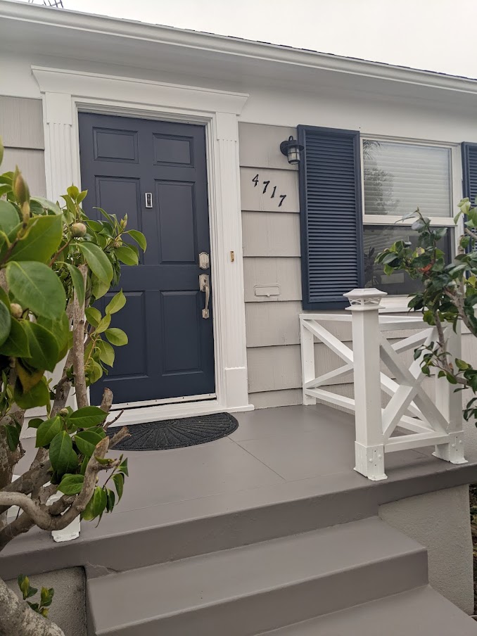 Front door painted Sherwin Williams Cyberspace, siding REquisite Gray, trim and railings High Reflective White, Gauntlet Gray concrete steps. Kylie M Interiors Edesign