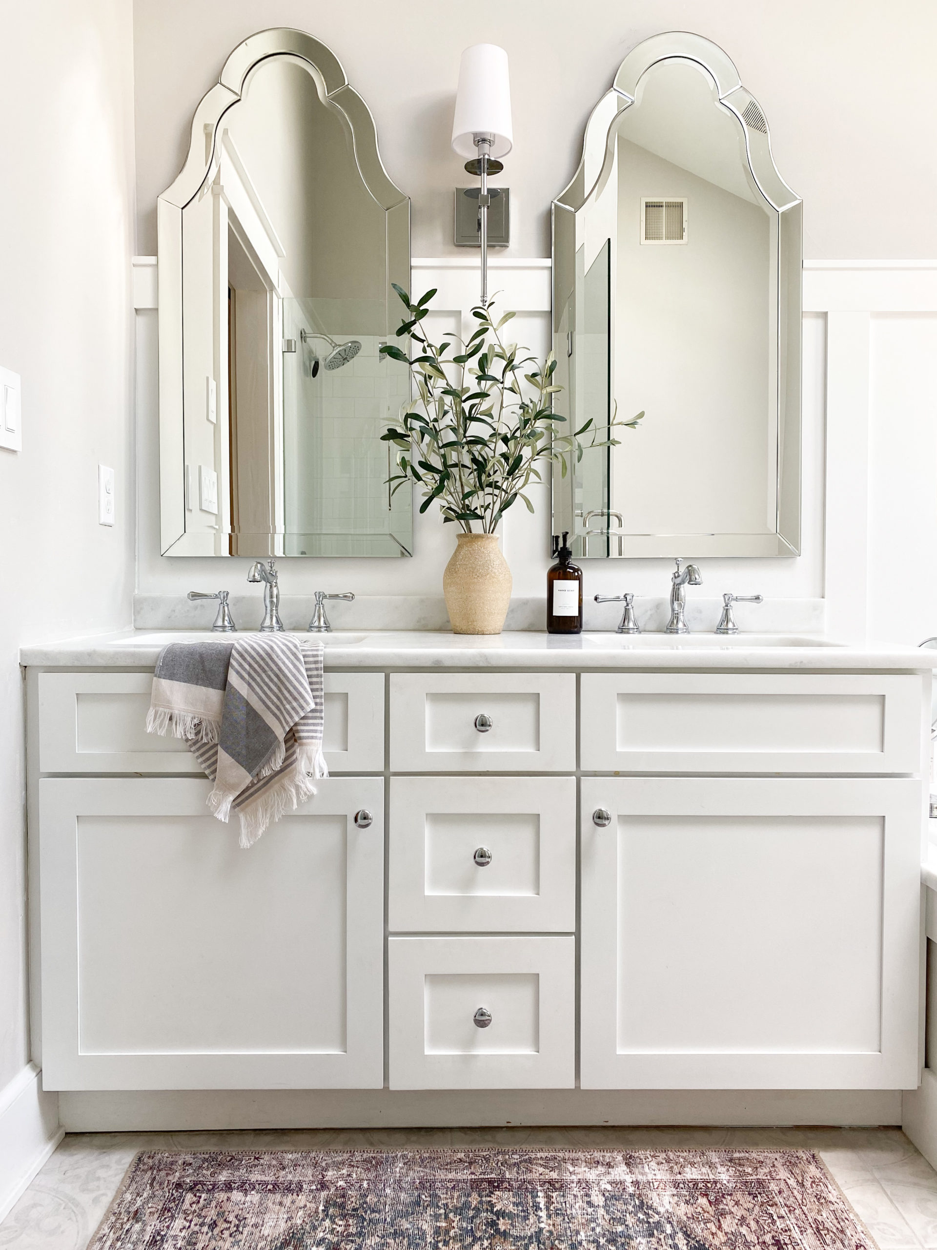 Sherwin Williams High Reflective White painted vanity, marble look quartz countertop, board and batten, arched mirrors, On the Rocks Sherwin. Kylie M Interiors Edesign