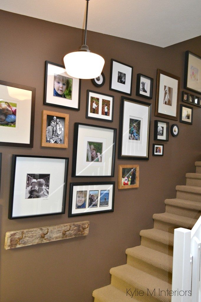 How to personalize a home with an art or photo gallery wall going up the stairs or staircase. On Benjamin Moore Chocolate Fondue by Kylie M Interiors