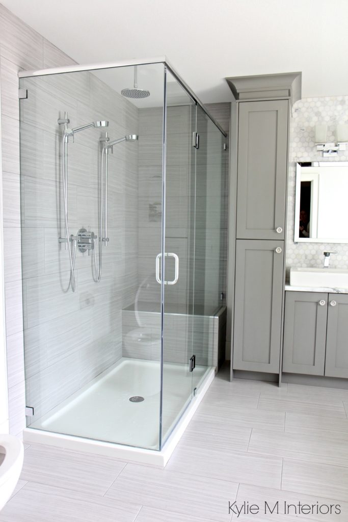 Ensuite bathroom with porcelain tile floor and large tile shower surround, glass doors and vanity painted Benjamin Moore Chelsea Gray by Kyilie M Interiors Online Consulting and E-Design