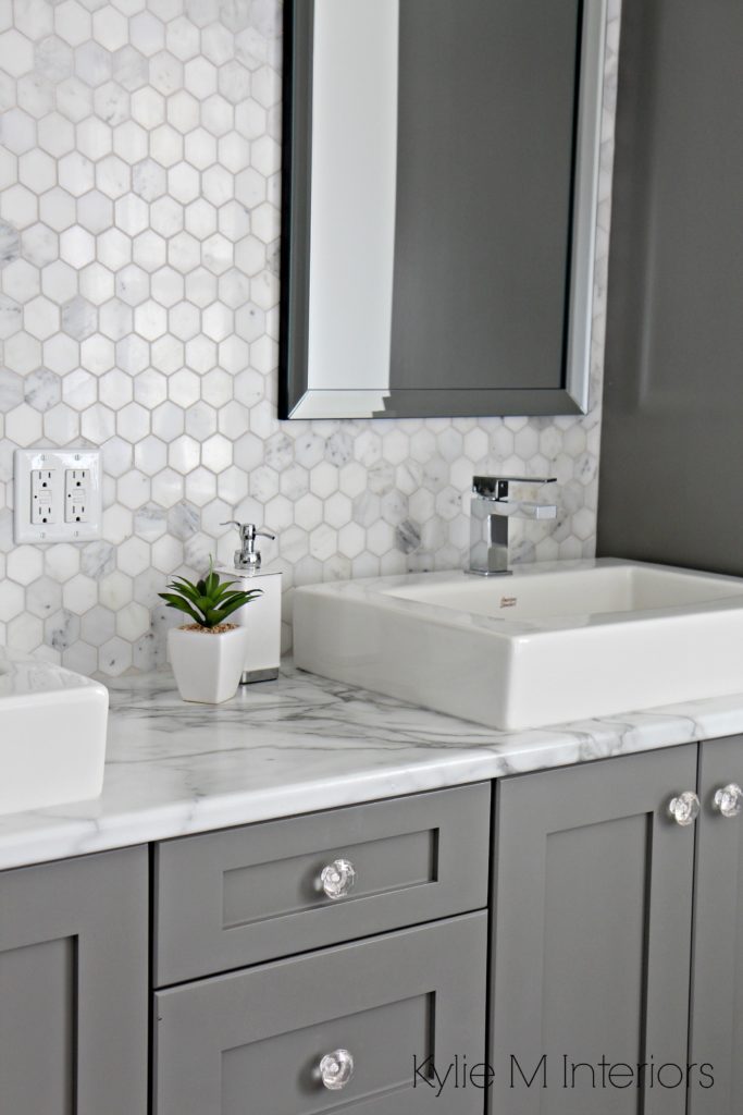 Formica 180FX Calacatta marble laminate countertop, hexagon mosaic marble backsplash and Chelse Gray vanity in ensuite bathroom with raised sinks by Kylie M Interiors