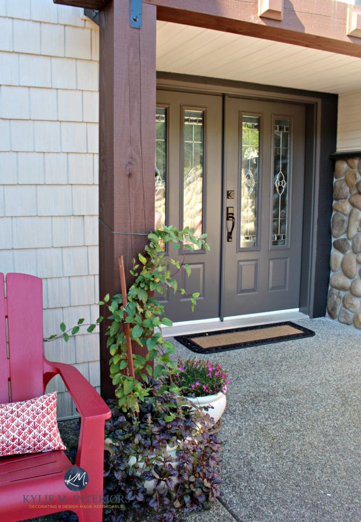 Sherwin Williams Gauntlet Gray painted front door with stone and cream vinyl siding. Kylie M E-design