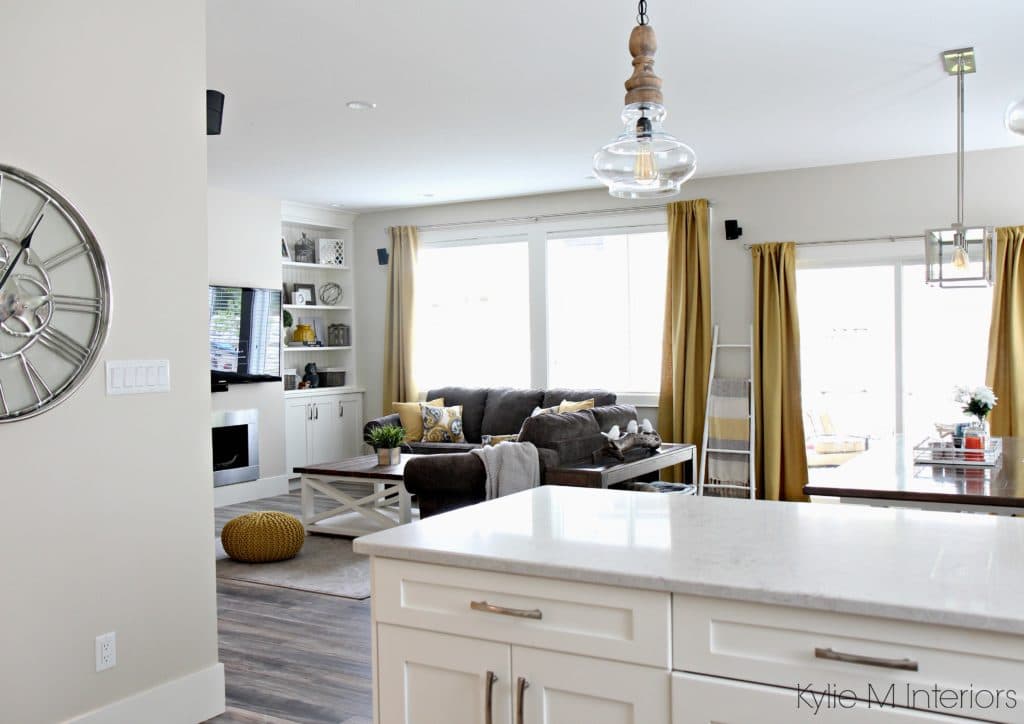 benjamin-moore-edgecomb-gray-with-bianco-drift-quartz-and-yellow-gold-accents-in-open-layout-living-room-dining-room-and-kitchen-by-kylie-m-interiors-online-e-decor-and-color-consulting