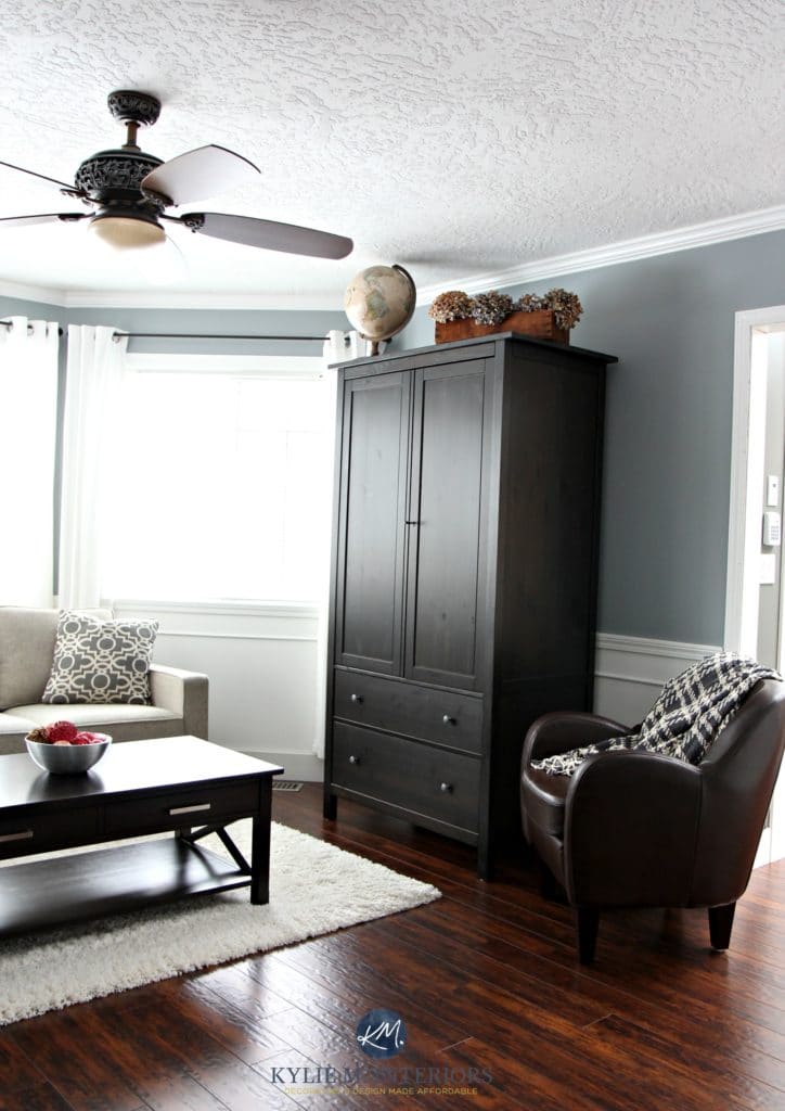Sherwin Williams Network Gray is one of the best cool gray paint colours with a a subtleblue undertone. shown with home decor and white wainscoting