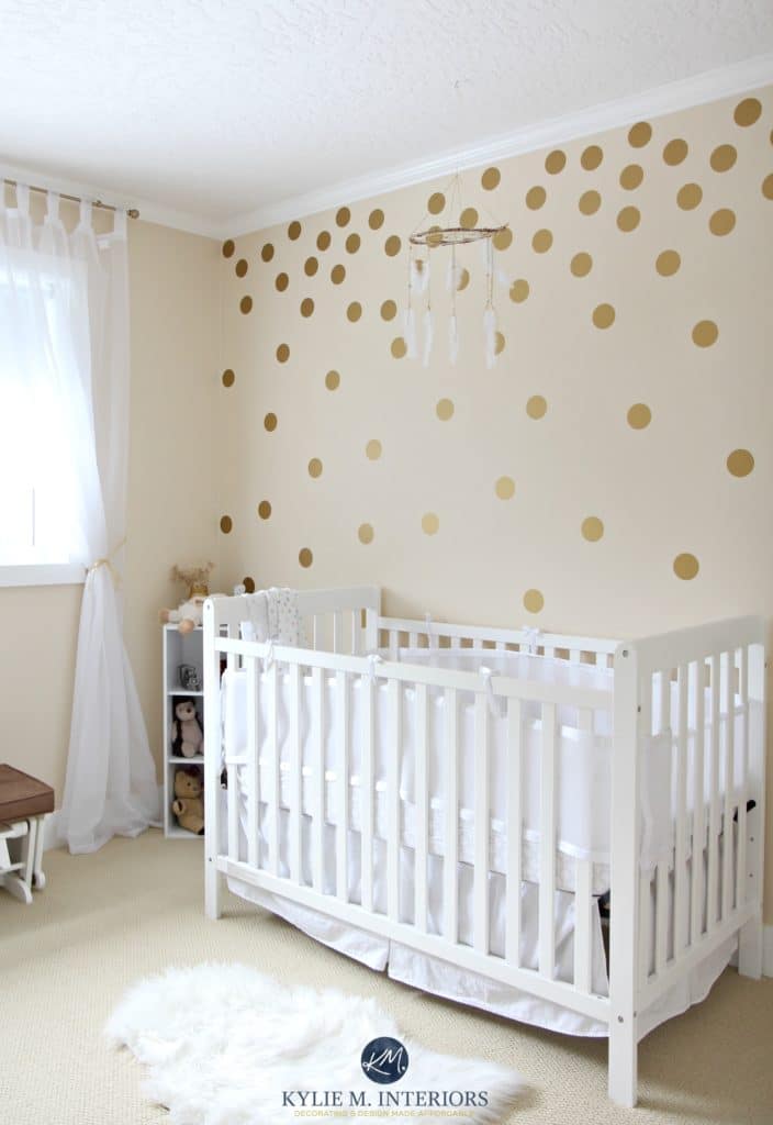 Benjamin Moore Gentle Cream in a gender neutral baby nursery with gold polka dots and white crib. Kylie M Interiors