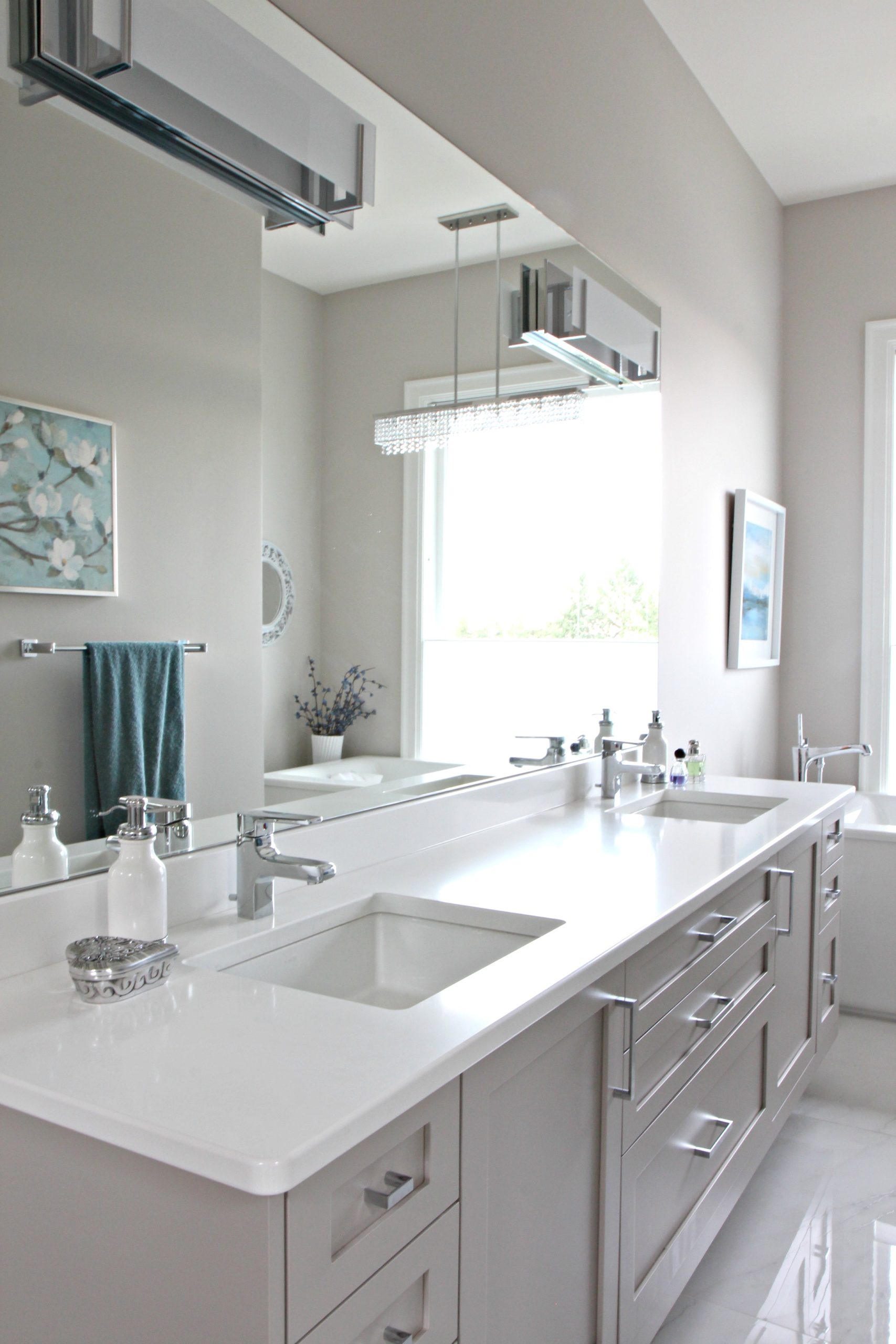 Bathroom with floating gray vanity, Cambria quartz countertop Kirkstead. Benjamin Moore Balboa Mist, large mirror. Kylie M Interiors Decorating and Design Online and Nanaimo