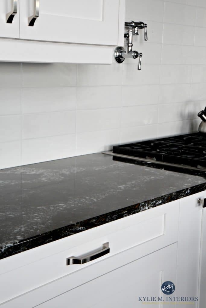 Cambria Ellesmere black quartz countertop, white kitchen cabinets and off-white light gray subway tile backsplash. Kylie M Interiors Decorating and Design