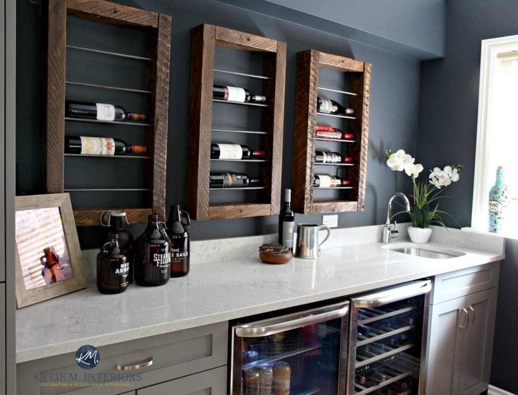 Home bar with wine display and storage, beer and wine fridge. Bianco Drift quart countertop, painted gray cabinets and Sherwin Williams Cyberspace. Kylie M INteriors E-design
