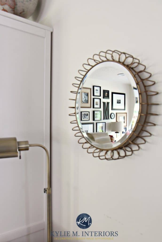 Round accent mirror with gold detail reflecting photo gallery. On Sherwin Williams Creamy paint colours. Kylie M Interiors Virtual and e-design