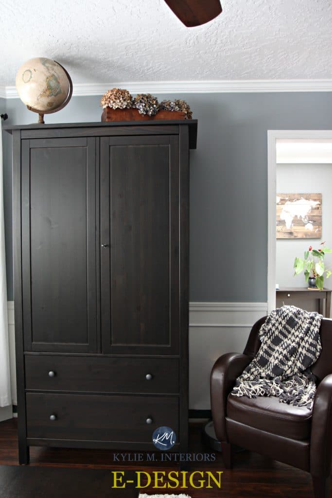 Sherwin Williams Network Gray with dark wood armoire and red tone wood flooring. White trim. Transitional style. Kylie M Interiors E-design and online colour consulting