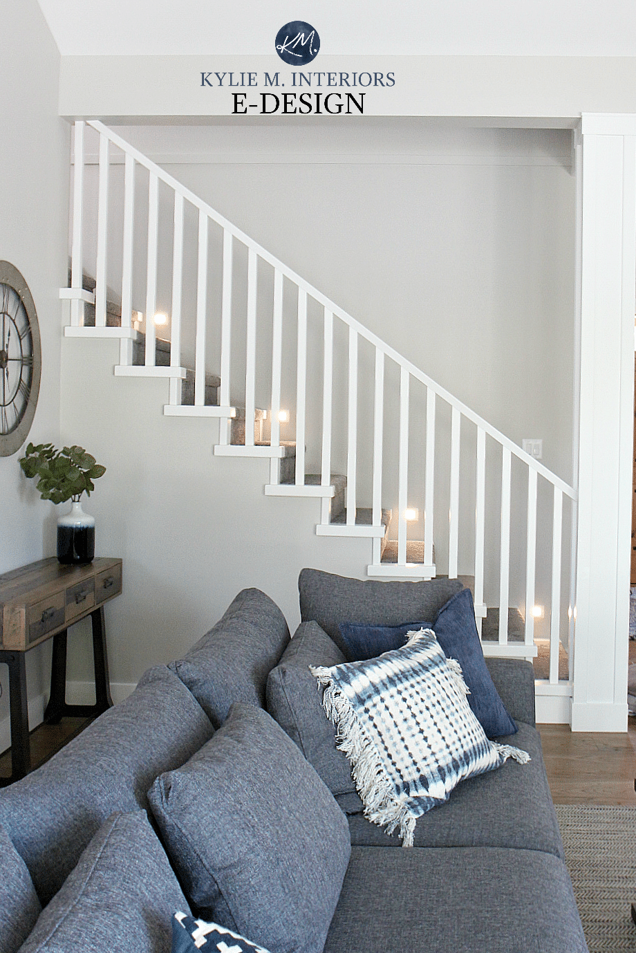 Staircase with lights, carpet, wood flooring, white railings. Stonington Gray paint color. Kylie M Interiors Edesign, online paint colour expert