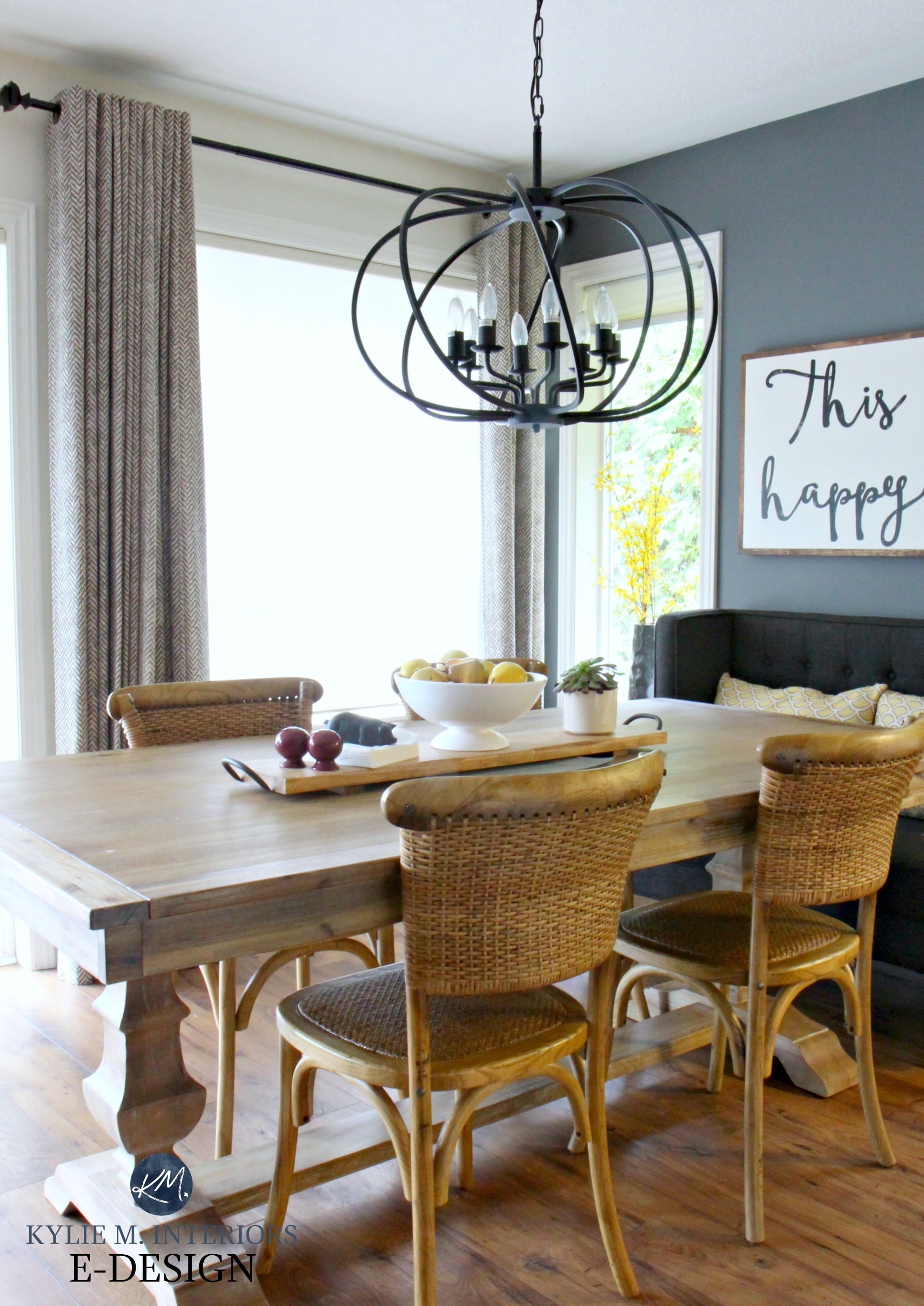 Farmhouse dining table with wicker chairs, chandelier. Kylie M E-design