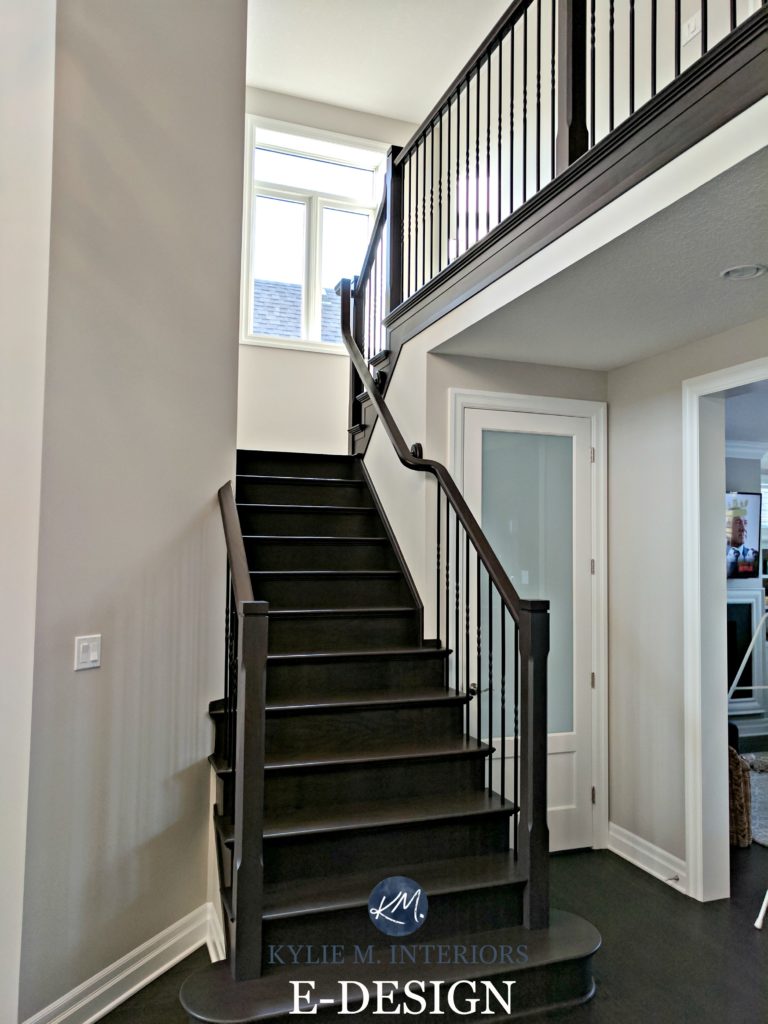 Benjamin Moore Collingwood in a staircase with dark wood stair treads, black handrail. Kylie M INteriors E-design and online color consulting blog