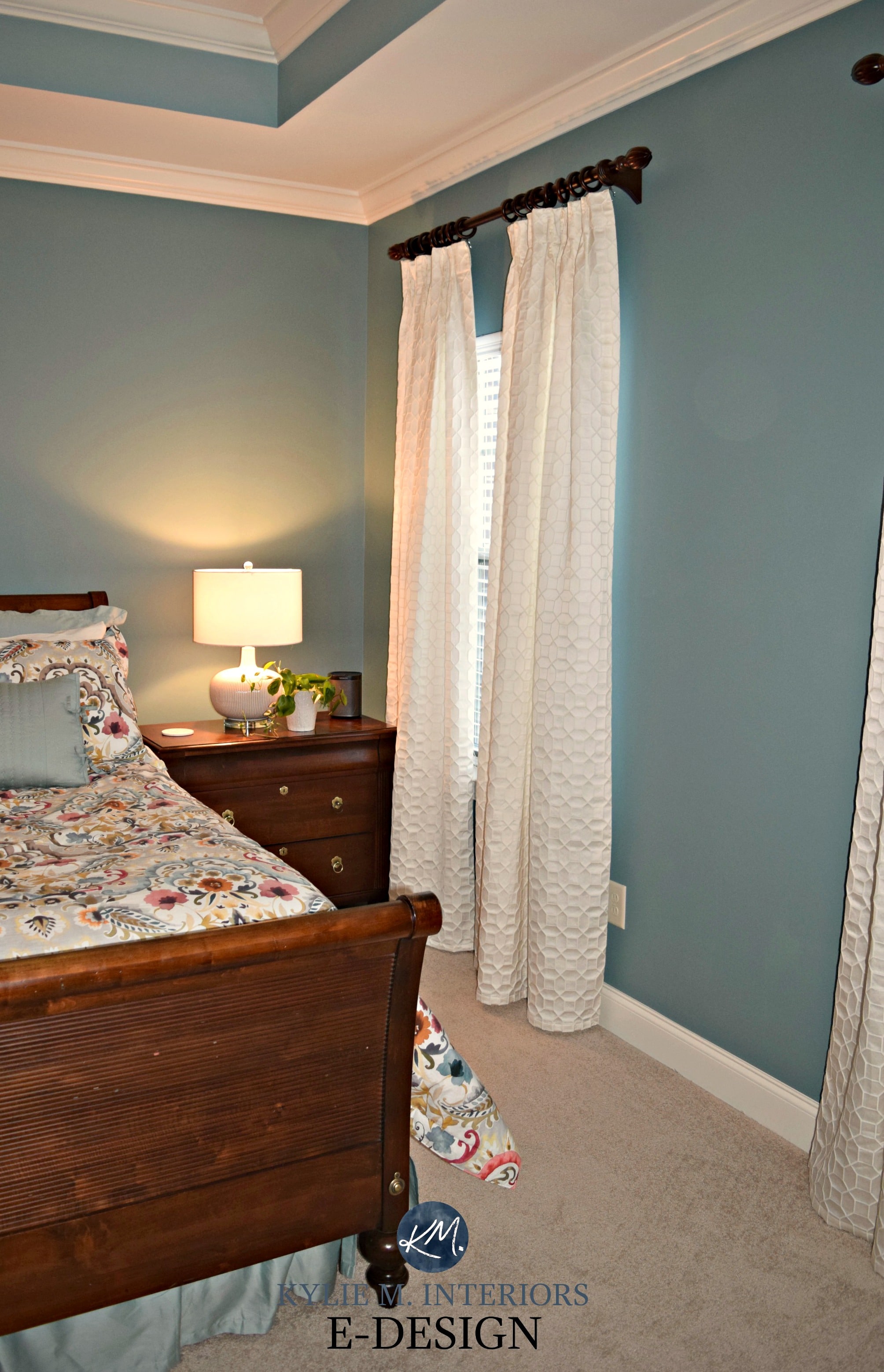 Sherwin Williams Moody Blue, master bedroom, beige carpet, white drapes, wood furniture. Kylie M E-design, online paint color consultant