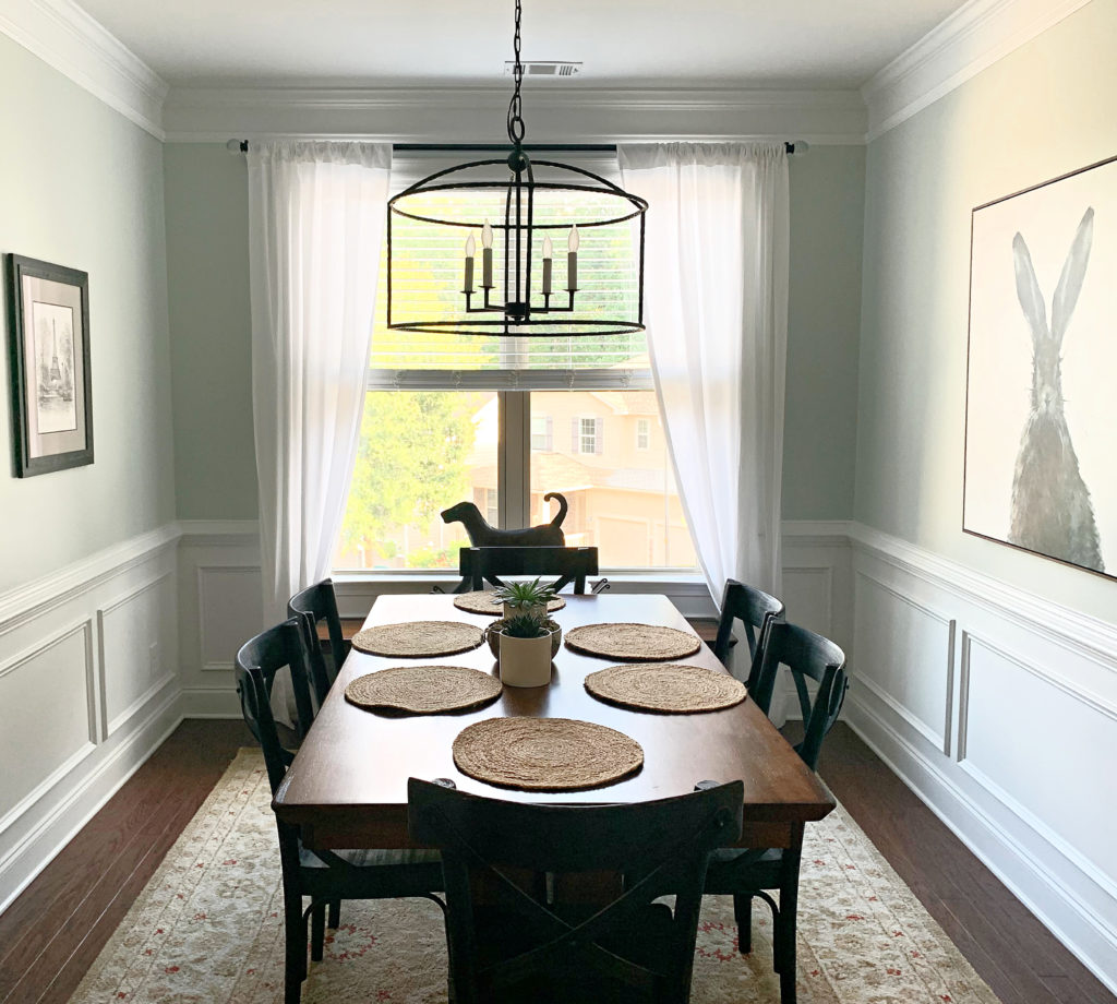 Sherwin Williams Sea Salt in dining room, likely north-facing with white wainscoting and dark wood table. Kylie M Interiors CLIENT PHOTO