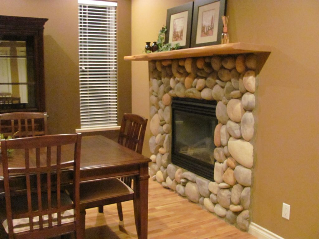 family room before painting with stone riverrock fireplace