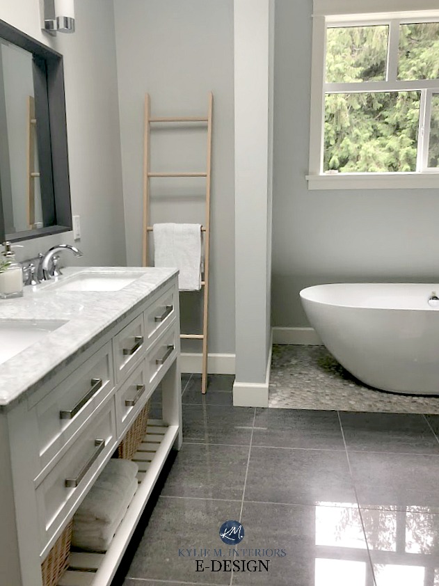 Bathroom, freestanding tub on pebble tile floor. Wickham Gray paint colour, white cabinet with marble countertop. Kylie M Interiors Edesign, online paint colour expert and consultant