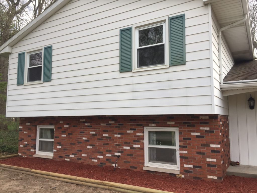 Exterior split level with siding and brick BEFORE painting 