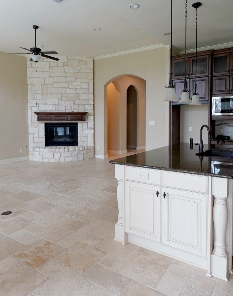 Sherwin Williams Antique White with traavertine floor and beige walls and stone fireplace. Kylie M INteriors Edesign, online paint color consultant