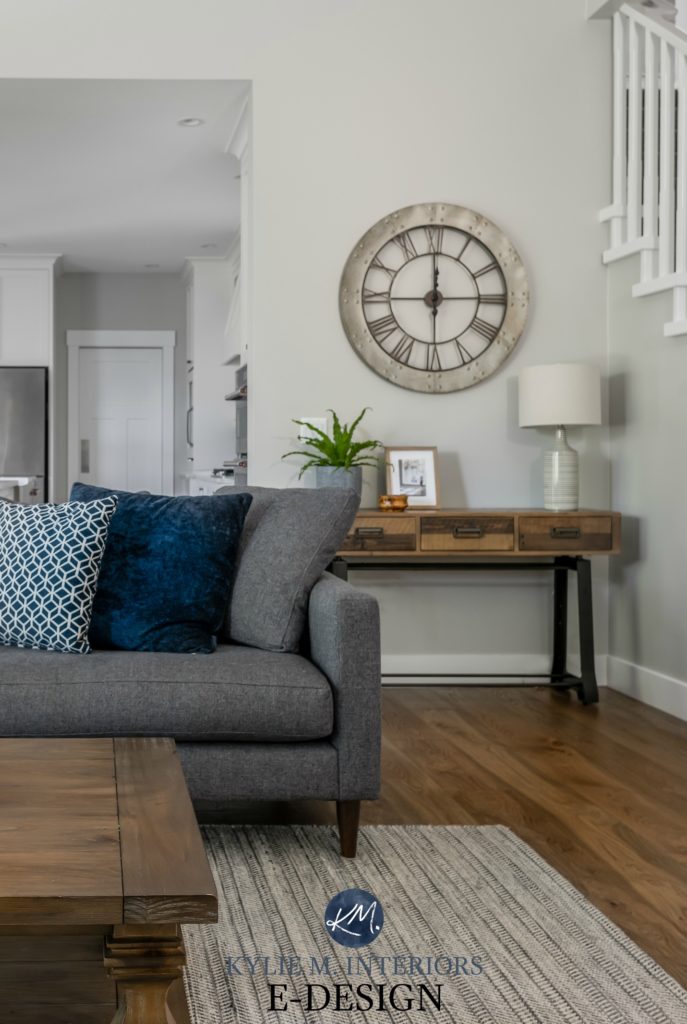Living room with gray sectional, Stonington Gray paint color on the walls, oak flooring. Large clock and rustic wood furniture. Kylie M Interiors Edesign, online paint colour consulting blog