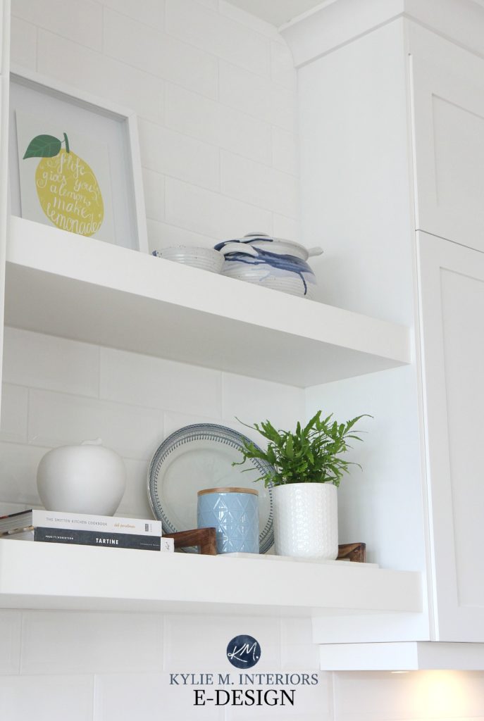 Open floating shelves in white kitchen with white bevelled subway tile and decor. Kylie M Interiors Edesign, online paint color consultant and decorating blog