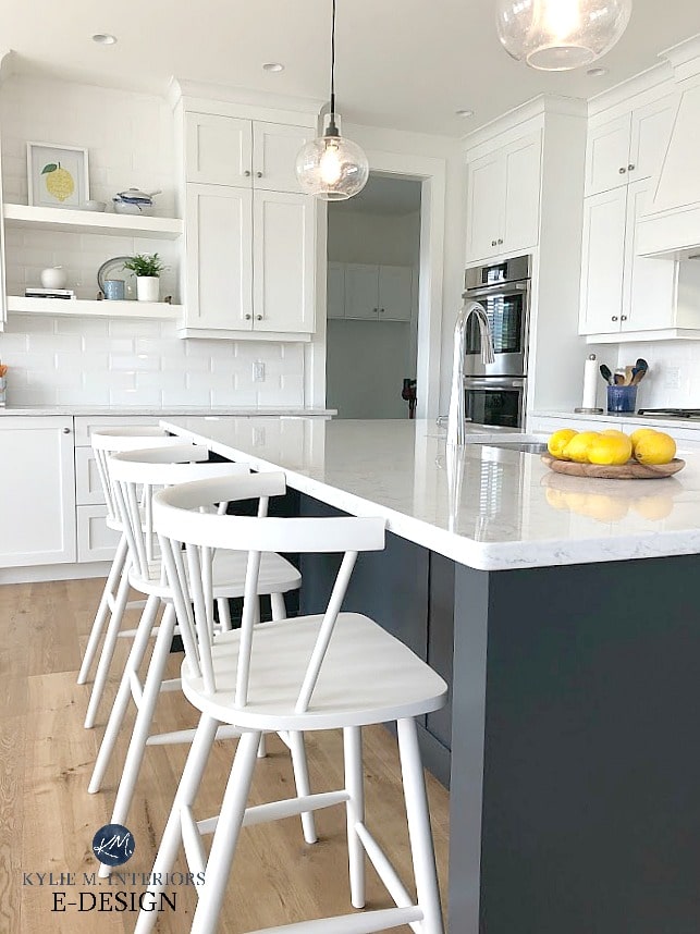 Pure White kitchen cabinets, white bevelled subway tile backsplash, white quartz, counter stools and floating shelves with home decor. Kylie M Interiors Edesign, online paint color advice blog