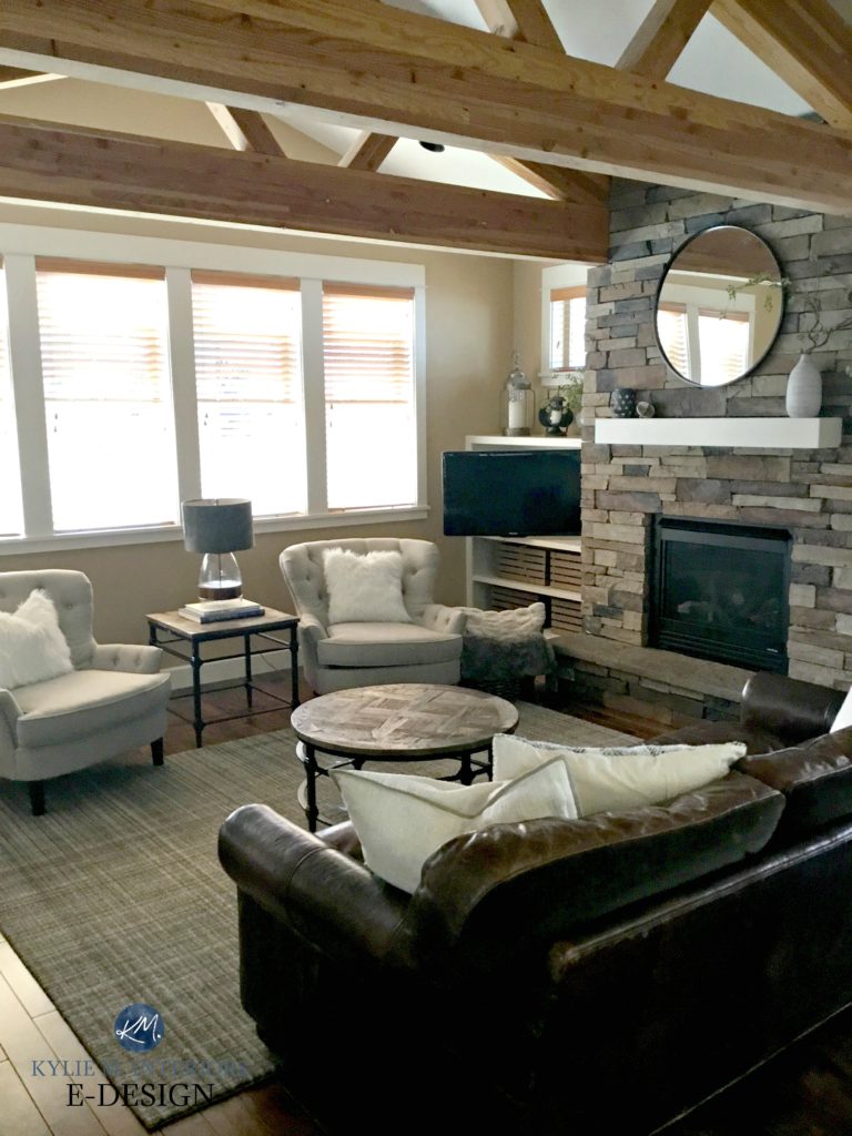 Rustic cozy living room, wood beams, stone fireplace, balaned chair layout. Palm Desert Tan, Benjamin Moore walls. Fireplace mantel. Kylie M Interiors Edesign, online paint color consulting