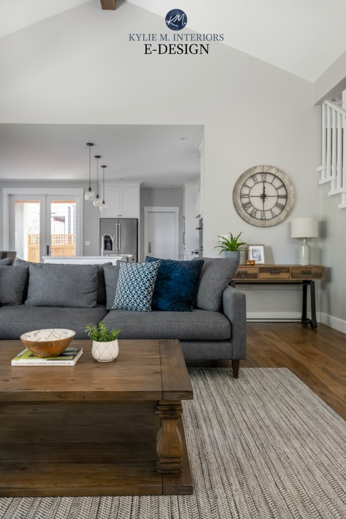 Open layout living room, kitchen, gray sectional, Stonington Gray paint colour, rustic wood furniture, navy blue accents. Kylie M Interiors Edesign, online paint colour, design expert
