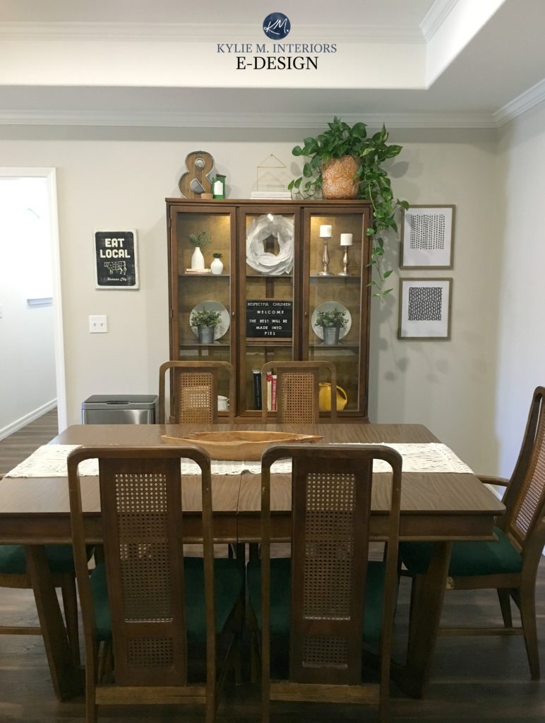 Dining room in Sherwin Williams Agreeable Gray, traditional style wood table and china cabinet with decor. Kylie M Interiors Edesign, online best paint color expert