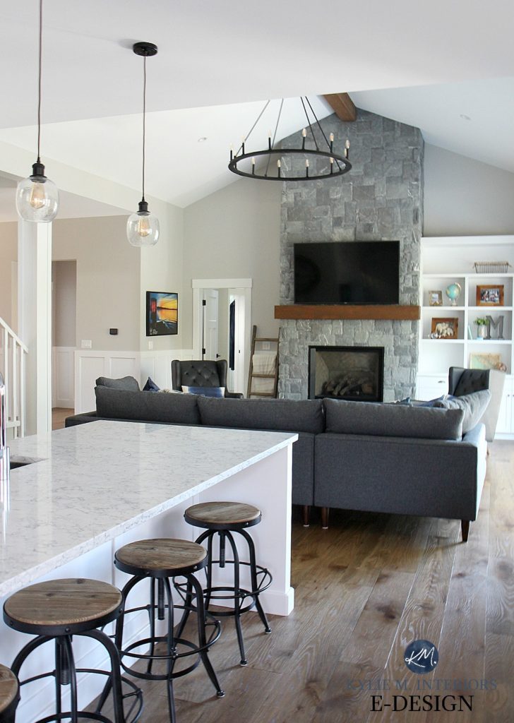 White LG Quartz countertop, open layout kitchen and living room. Gray stone fireplace, Stonington Gray paint on walls, gray sectional. Kylie M Interiors Edesign, online paint blogger and consultant