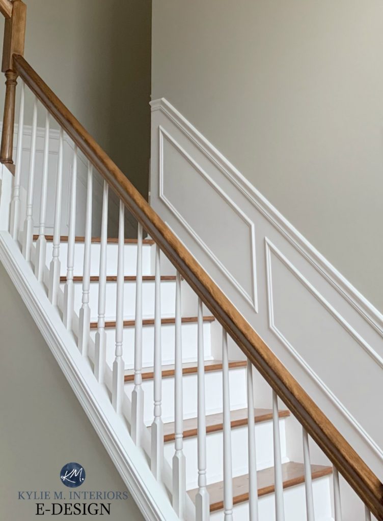 Best tan beige paint colour, Benjamin Moore Grant Beige, neutral color in stairwell with wood railing, white railing and wainscoting. Kylie M Interiors Edesign, online paint colour advice blog