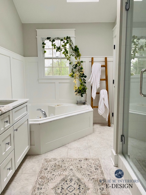Sherwin Williams On the Rocks, light gray paint color in bathroom, Extra White wainscoting, tile floor. Corner tub, Kylie M INteriors Edesign