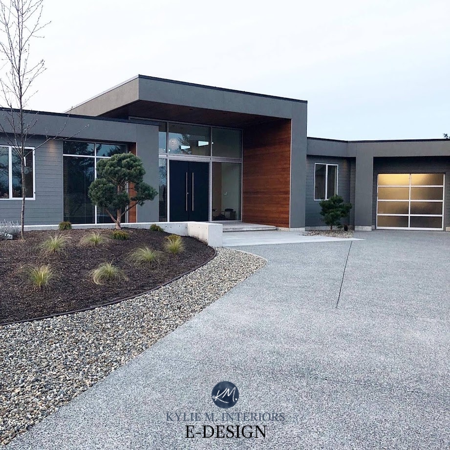 Contemporary modern exterior, gray stucco, black front door, garage doors, wood detail. Kylie M Interiors Edesign, online paint color consulting, virtual design