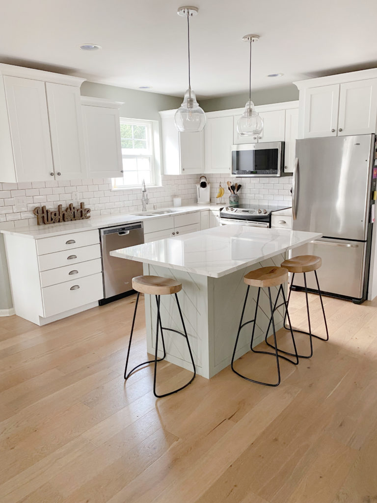 South-west facing kitchen, Sherwin Williams Pure White cabinets, light red oak floor and Sherwin Williams Austere gray walls, green island. South west .. CLIENT PHOTO Kylie M Interiors Edesign (1