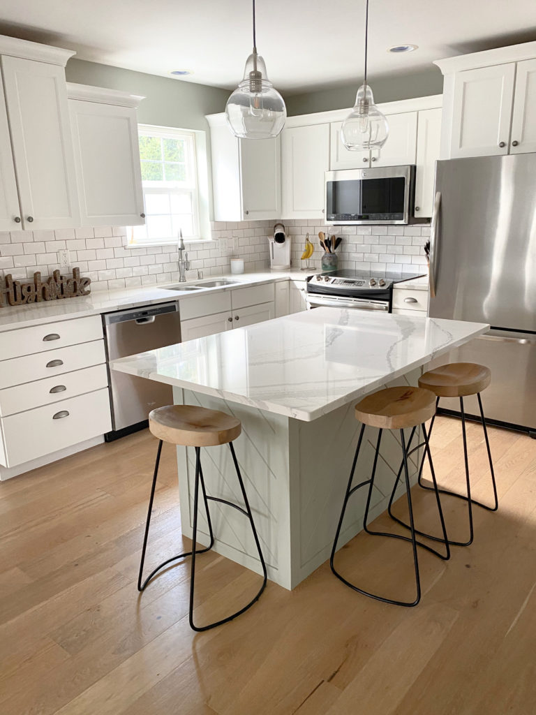 South-west facing kitchen, Sherwin Williams Pure White cabinets, light red oak floor and Sherwin Williams Austere gray walls, green island. South west .. CLIENT PHOTO Kylie M Interiors Edesign
