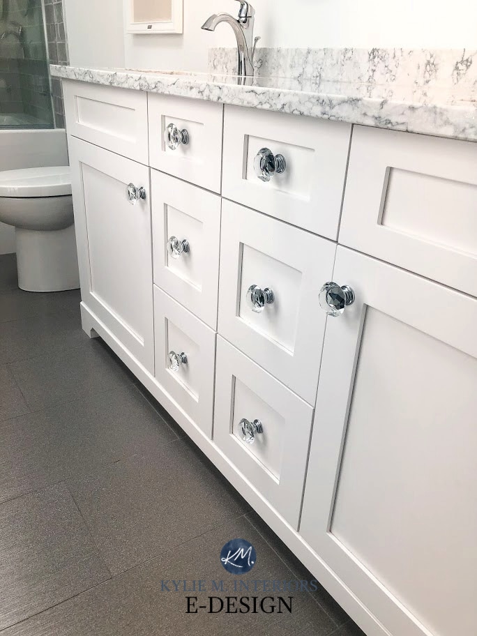 Sherwin Williams High Reflective White on bathroom vanity, gray floor tile, LG Viatara Quartz countertop, crystal knobs. Kylie M Interiors Edesign