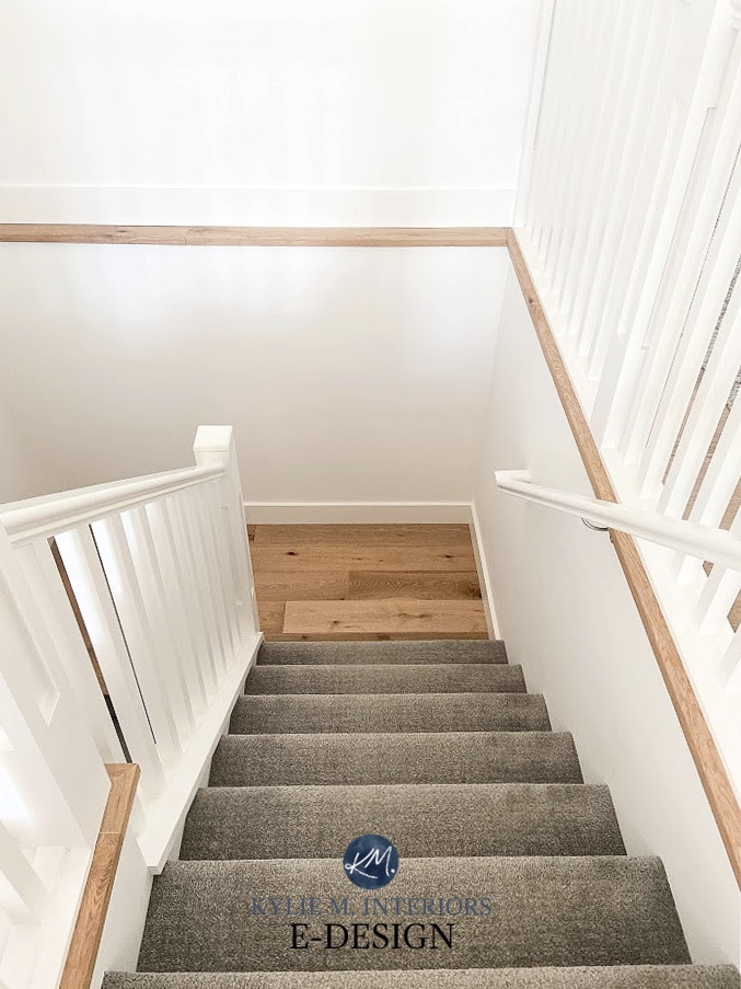Stairs with carpet, wood landing, white railings, white walls, Benjamin Moore Super White. Kylie M Interiors Edesign, online paint color advice
