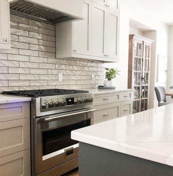 Warm gray subway tile backsplash, Revere Pewter gray painted cabinets, Cambria quartz countertop, stainless steel Fulgor appliances. Kylie M Interiors Edesign, diy blogger