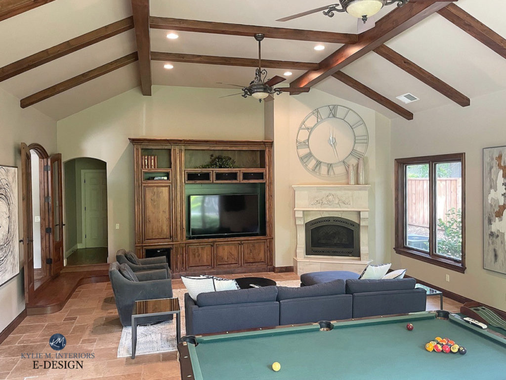 Games room, family room with green felt pool table, travertine tile floor, fireplace, wood beams and wood trim, Sherwin Pavillion Beige paint colour on walls, blue sectional, wood built ins, Kylie M (1)