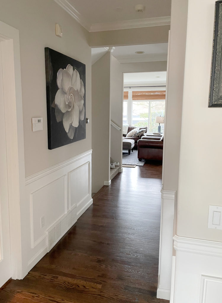 Hallway with dark oak wood floor, Benjamin Moore White Dove wainscoting, paint colour similar to lightened Edgecomb Gray (Sherwin Warm Putty - old colour).