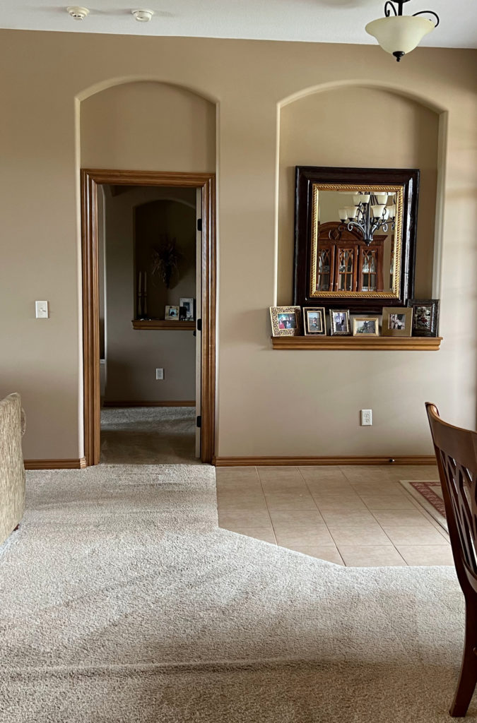 Sherwin Williams Latte with beige carpet and beige entryway tile, arched niche and wood trim